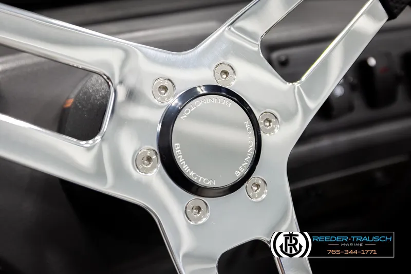 Slide: The Image of Close-up of 2026 Bennington SLSF steering wheel with chrome finish and logo. - 28