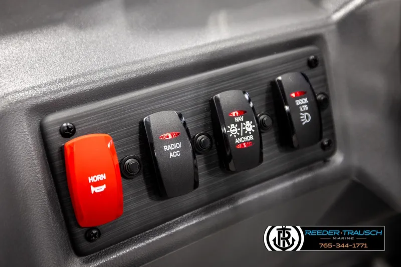 Slide: The Image of Control panel of 2026 Bennington SLSF boat with horn, radio, and light switches. - 29