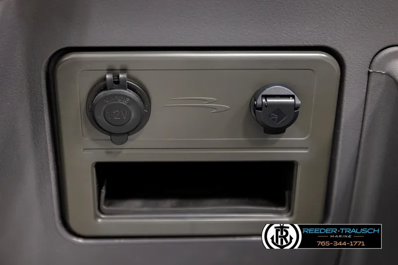 Slide: The Image of 2026 Bennington SLSF marine 12V power outlet and accessory port panel. - 35