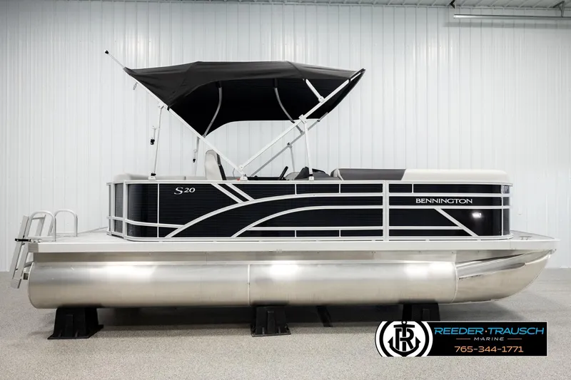 Slide: The Image of 2026 Bennington SLSF pontoon boat with canopy in showroom display. - 5