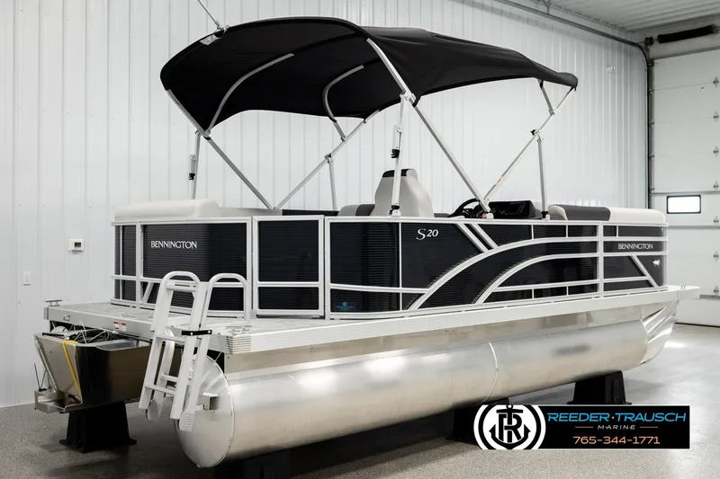 Slide: The Image of 2026 Bennington SLSF pontoon boat with canopy in showroom. - 6