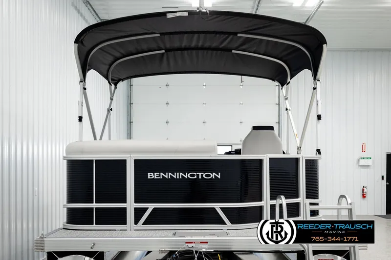 Slide: The Image of 2026 Bennington SLSF pontoon boat with canopy in a showroom. - 7