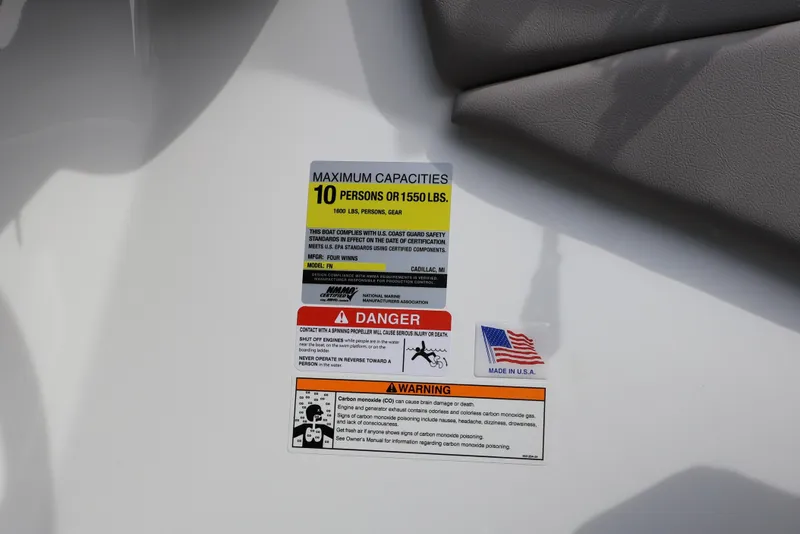 Slide: The Image of Safety and capacity labels on 2026 Four Winns HD2 boat, made in USA. - 17