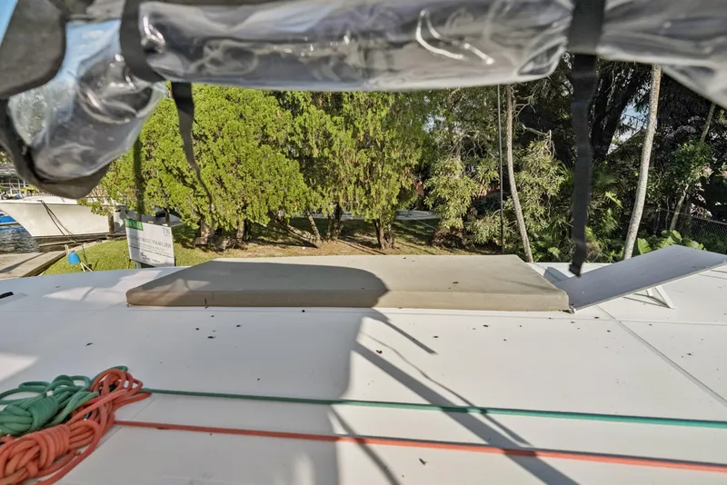 Slide: The Image of Rooftop view of 2020 Lagoon 42 catamaran with trees in the background. - 10