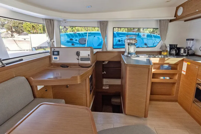 Slide: The Image of Interior of 2020 Lagoon 42 catamaran with modern kitchen and seating area. - 16