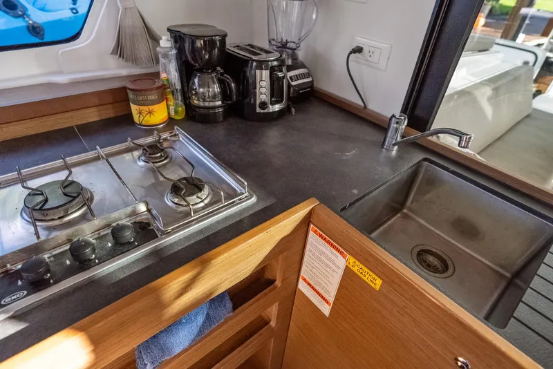 Slide: The Image of Modern kitchen in 2020 Lagoon 42 yacht with stove, sink, and appliances. - 18