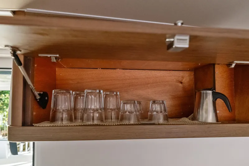 Slide: The Image of Cabinet in Lagoon 42 yacht with glasses and kettle, 2020 model. - 22