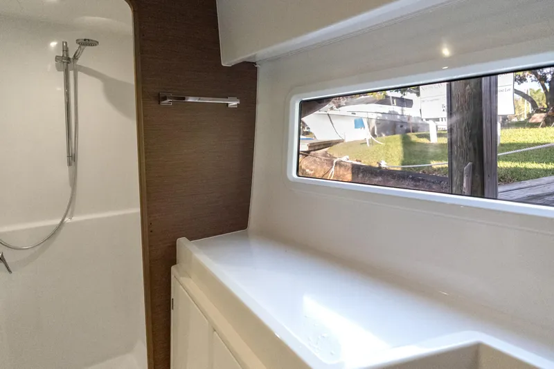 Slide: The Image of Interior of 2020 Lagoon 42 yacht bathroom with shower and window view. - 29