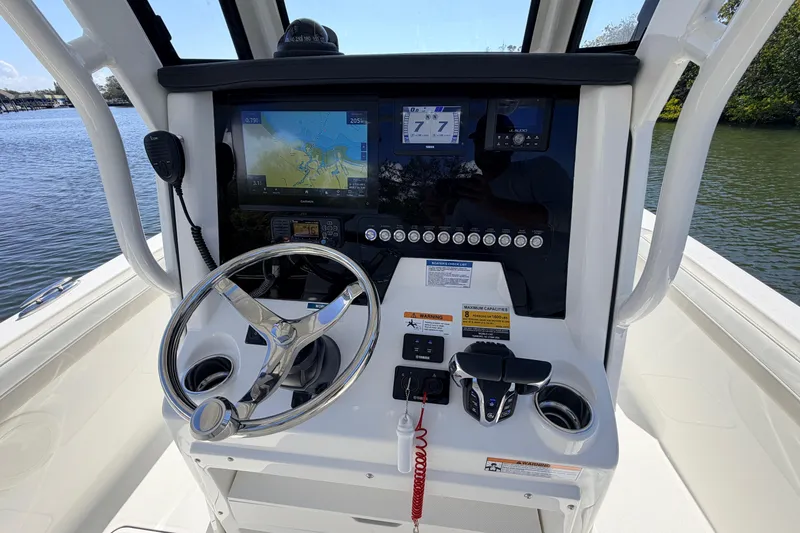 Slide: The Image of 2026 World Cat 235 TE boat dashboard with navigation system and steering wheel. - 10