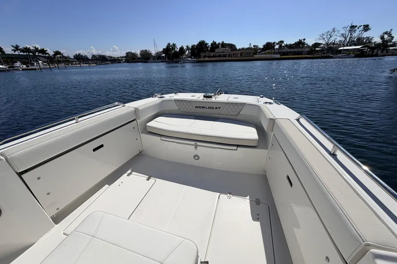 Slide: The Image of 2026 World Cat 235 TE boat interior with seating, on a sunny day by the water. - 11