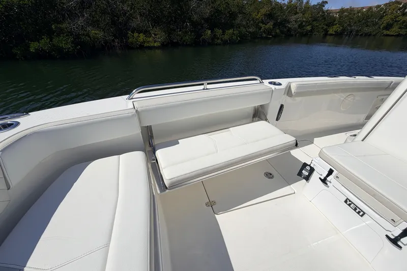Slide: The Image of 2026 World Cat 235 TE boat interior with white seating and scenic water view. - 12