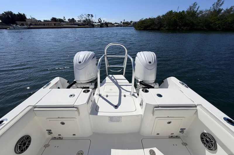 Slide: The Image of 2026 World Cat 235 TE boat with dual engines on a serene waterway. - 7