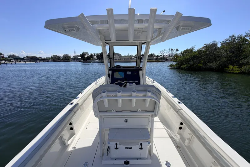 Slide: The Image of 2026 World Cat 235 TE boat on calm water, featuring a spacious deck and modern console. - 8