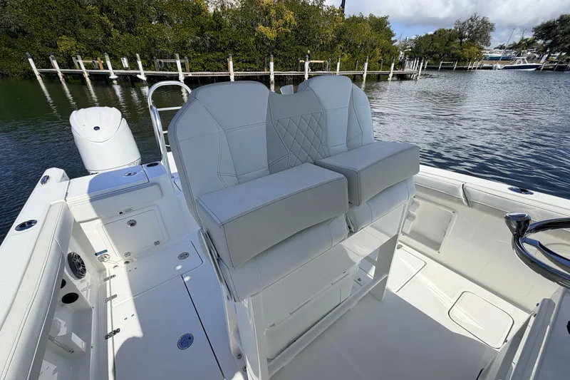 Slide: The Image of 2026 World Cat 235 TE boat interior with dual seats, dockside view. - 9
