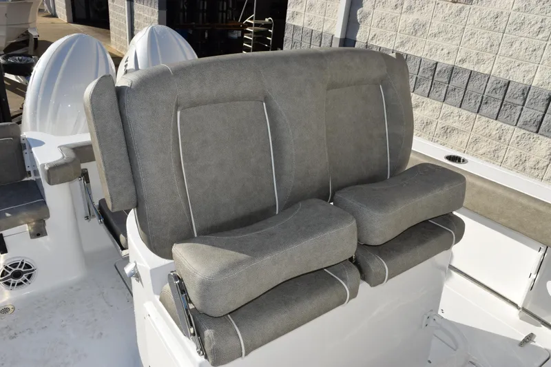 Slide: The Image of 2026 Sea Hunt Gamefish 25 boat seating with gray upholstery and dual outboard motors. - 11