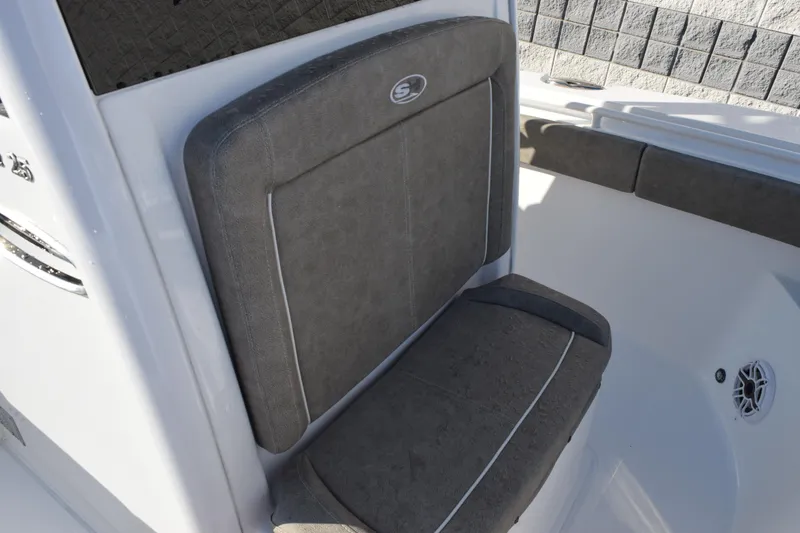 Slide: The Image of 2026 Sea Hunt Gamefish 25 boat seat with gray upholstery and white accents. - 13