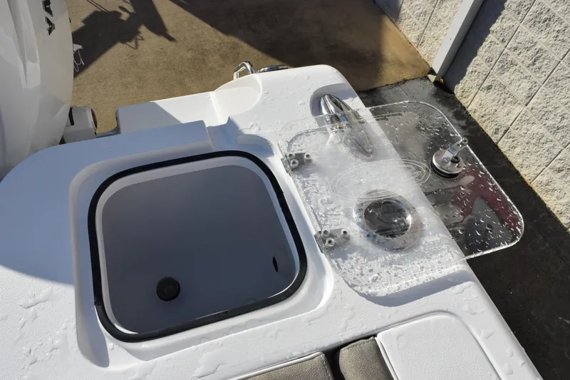 Slide: The Image of 2026 Sea Hunt Gamefish 25 boat with livewell and clear lid, showcasing fishing amenities. - 17