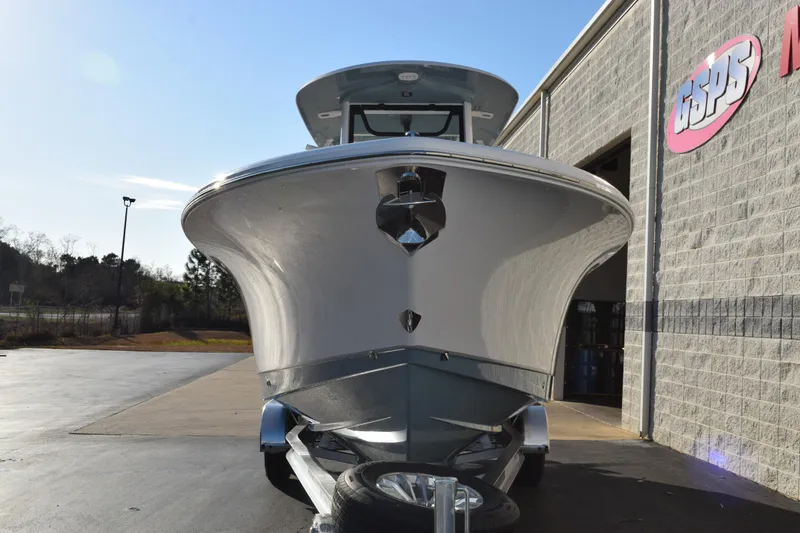 Slide: The Image of 2026 Sea Hunt Gamefish 25 boat parked outside a building on a sunny day. - 3