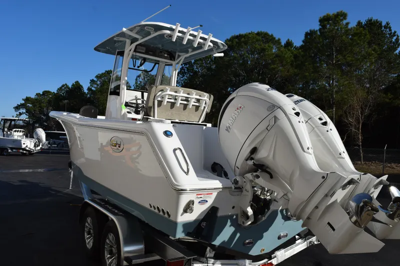 Slide: The Image of 2026 Sea Hunt Gamefish 25 boat with dual Yamaha outboard engines on a trailer. - 6
