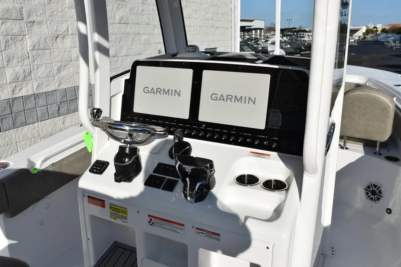 Slide: The Image of 2026 Sea Hunt Gamefish 25 boat console with dual Garmin displays and controls. - 9