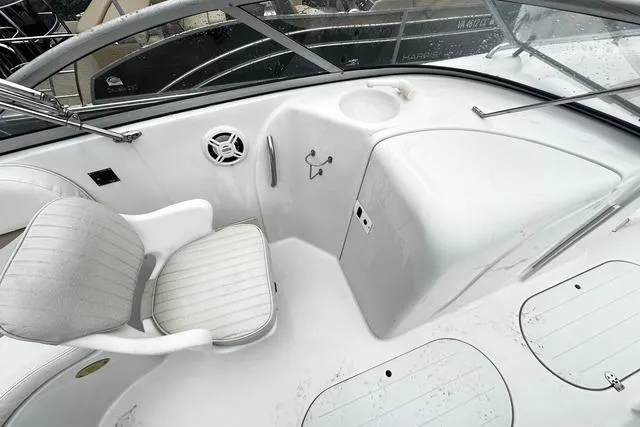 Slide: The Image of 2005 Starcraft Aurora 2210 OB boat interior with white seating and console. - 10