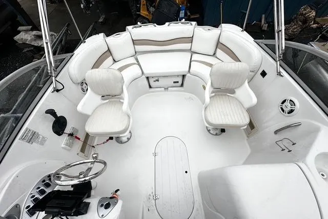 Slide: The Image of 2005 Starcraft Aurora 2210 OB boat interior with white seating and steering console. - 5
