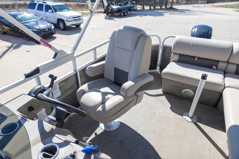Slide: The Image of 2023 Sun Tracker Party Barge 20 DLX interior with captain's chair and seating area. - 12