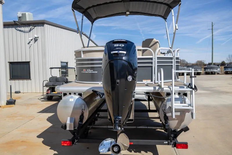 Slide: The Image of 2023 Sun Tracker Party Barge 20 DLX pontoon boat with Mercury 90 engine, docked outdoors. - 5