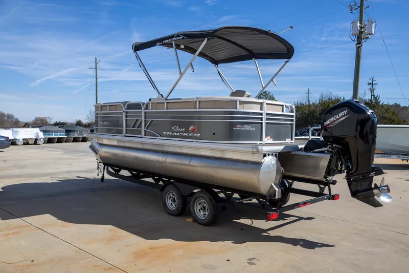 Slide: The Image of 2023 Sun Tracker Party Barge 20 DLX pontoon boat on trailer, with Mercury outboard motor. - 6
