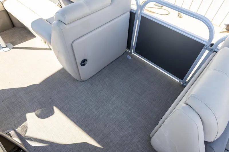 Slide: The Image of 2023 Sun Tracker Party Barge 20 DLX interior with gray flooring and comfortable seating. - 9