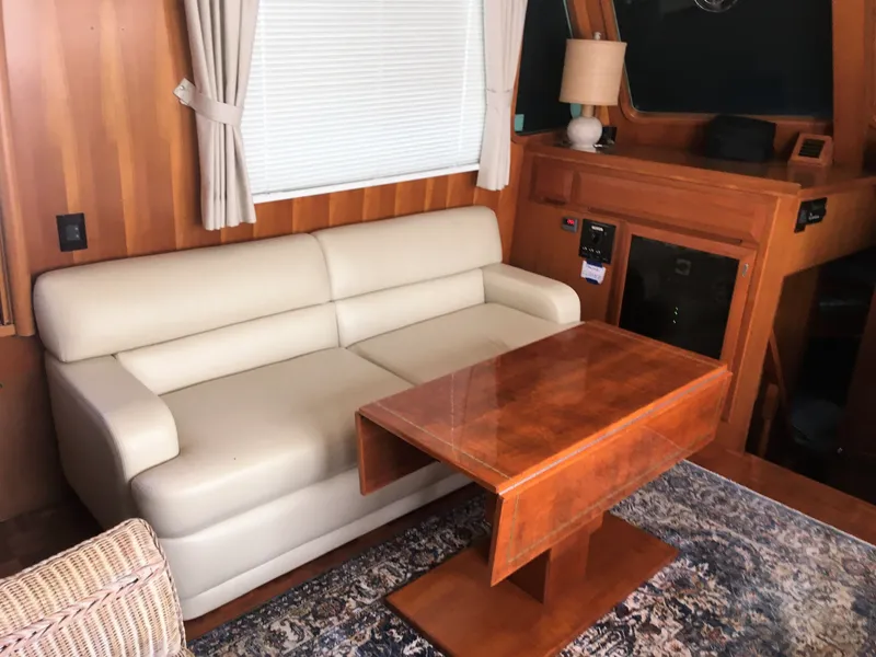 Slide: The Image of Interior of a 2005 DeFever 44+5 yacht with sofa and wooden table. - 30