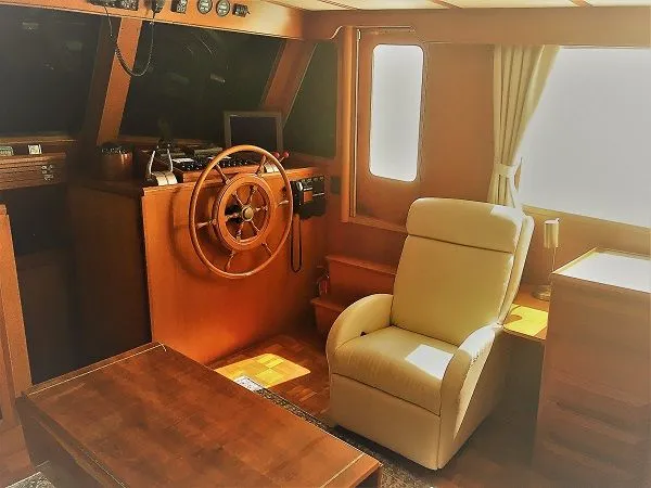 Slide: The Image of Interior of a 2005 DeFever 44+5 yacht with steering wheel and armchair. - 31
