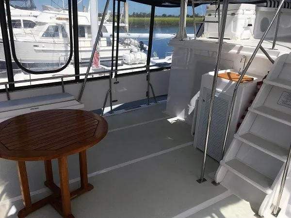 Slide: The Image of Interior of a 2005 DeFever 44+5 yacht with wooden table. - 7