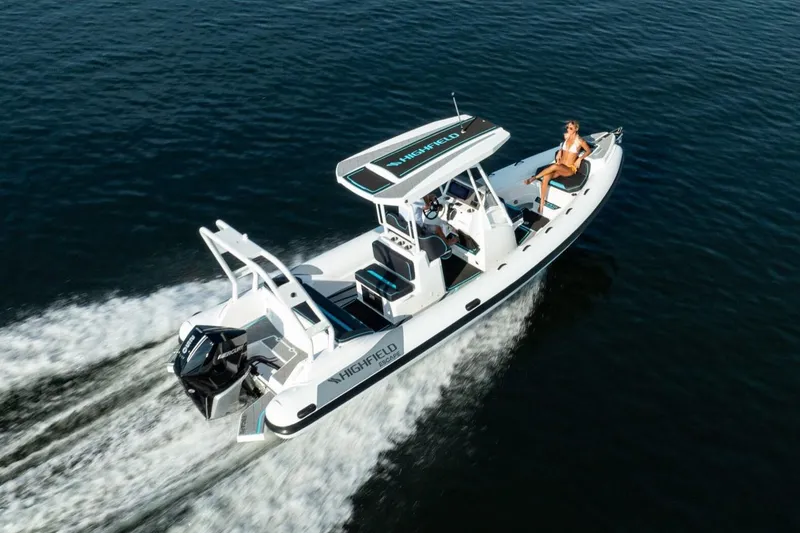 Slide: The Image of Manufacturer Provided Image: 2025 Highfield Escape 750 boat cruising on open water with passenger relaxing. - 2