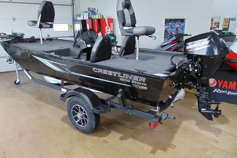 The Image of 2026 Crestliner 1600 Storm fishing boat with Mercury outboard motor in showroom. - 1