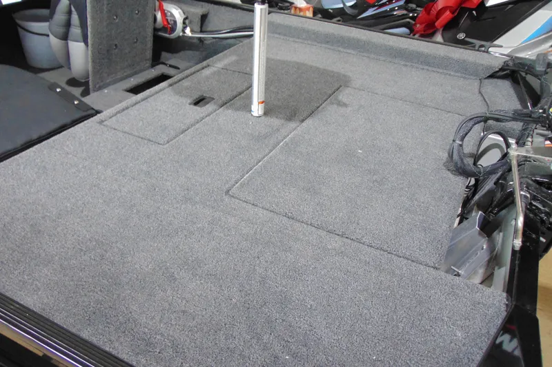 Slide: The Image of 2026 Crestliner 1600 Storm boat interior with carpeted deck and storage compartments. - 13