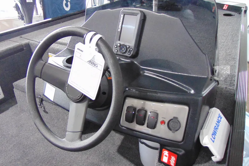 Slide: The Image of 2026 Crestliner 1600 Storm boat dashboard with steering wheel and Lowrance electronics. - 14