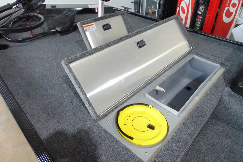 Slide: The Image of 2026 Crestliner 1600 Storm boat storage compartments with open lids and yellow hatch. - 7