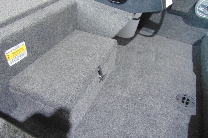 Slide: The Image of Interior of 2026 Crestliner 1600 Storm boat, featuring carpeted flooring and seating. - 9