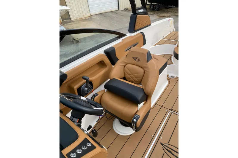 Slide: The Image of 2022 Chaparral 247 SSX boat interior with tan leather seating and modern controls. - 4