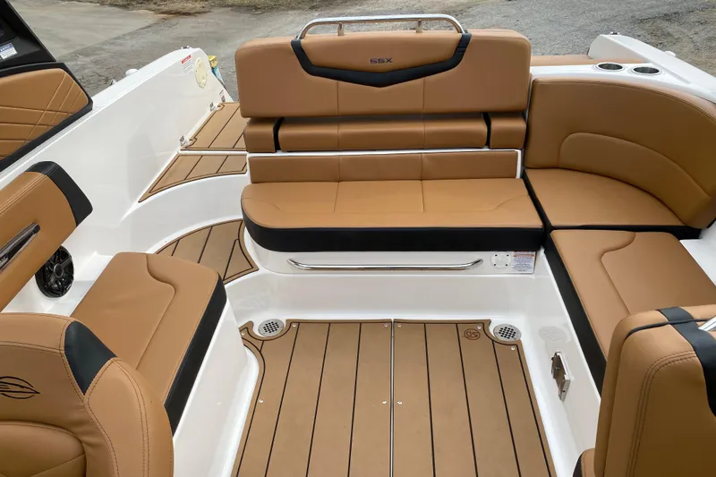 Slide: The Image of 2022 Chaparral 247 SSX boat interior with tan leather seating and teak-style flooring. - 8