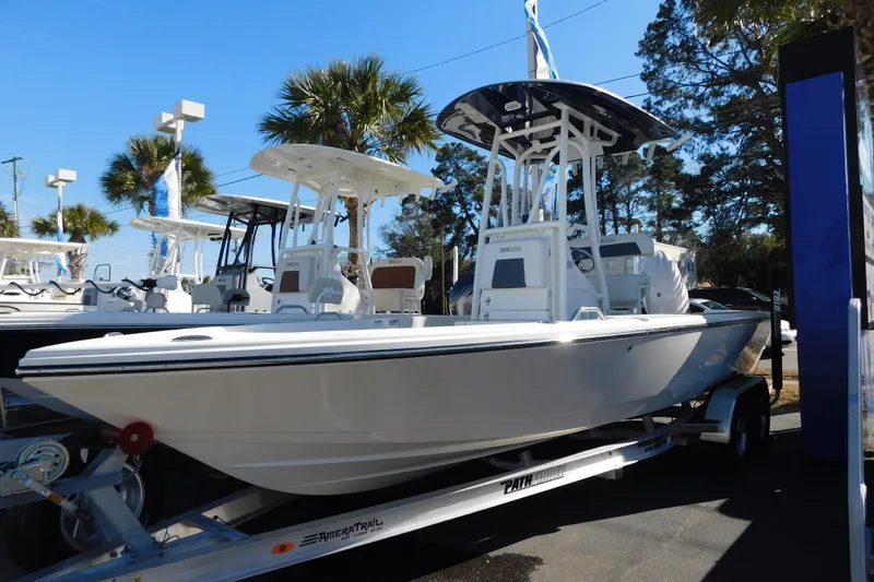 The Image of 2026 Pathfinder 2200 TRS boat on trailer, displayed outdoors under clear blue sky. - 0
