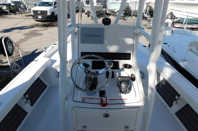 Slide: The Image of 2026 Pathfinder 2200 TRS boat console with Garmin navigation system, steering wheel, and controls. - 1