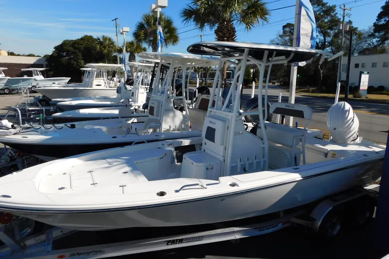 Slide: The Image of 2026 Pathfinder 2200 TRS boats displayed in a dealership lot under palm trees. - 11