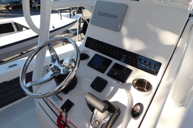 Slide: The Image of 2026 Pathfinder 2200 TRS boat console with Garmin navigation and steering wheel. - 13