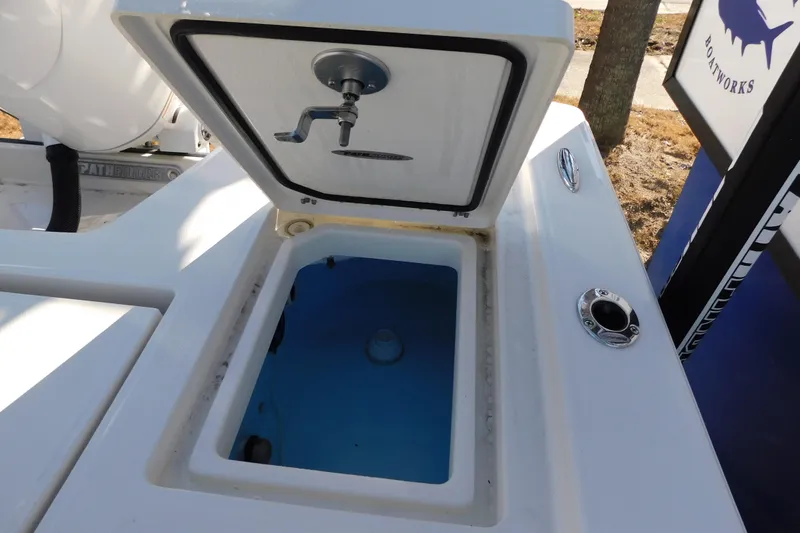 Slide: The Image of Open storage compartment on 2026 Pathfinder 2200 TRS boat, featuring a blue interior. - 17