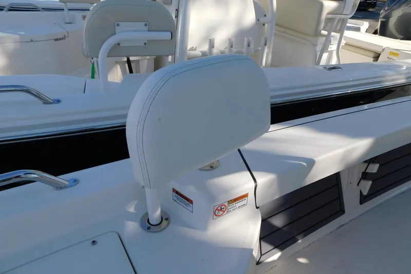 Slide: The Image of 2026 Pathfinder 2200 TRS boat interior with white seating and storage compartments. - 25