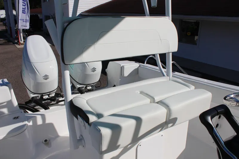 Slide: The Image of 2024 Clearwater 2300 CC boat with dual Suzuki outboard engines and cushioned seating. - 11