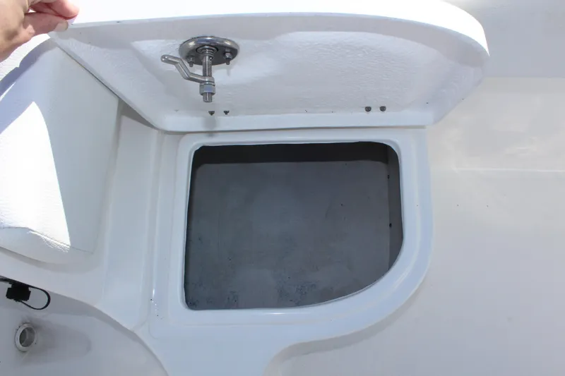 Slide: The Image of Open storage compartment on 2024 Clearwater 2300 CC boat. - 14