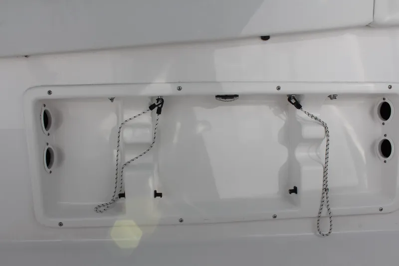 Slide: The Image of 2024 Clearwater 2300 CC boat transom with rope attachments and drainage outlets. - 18